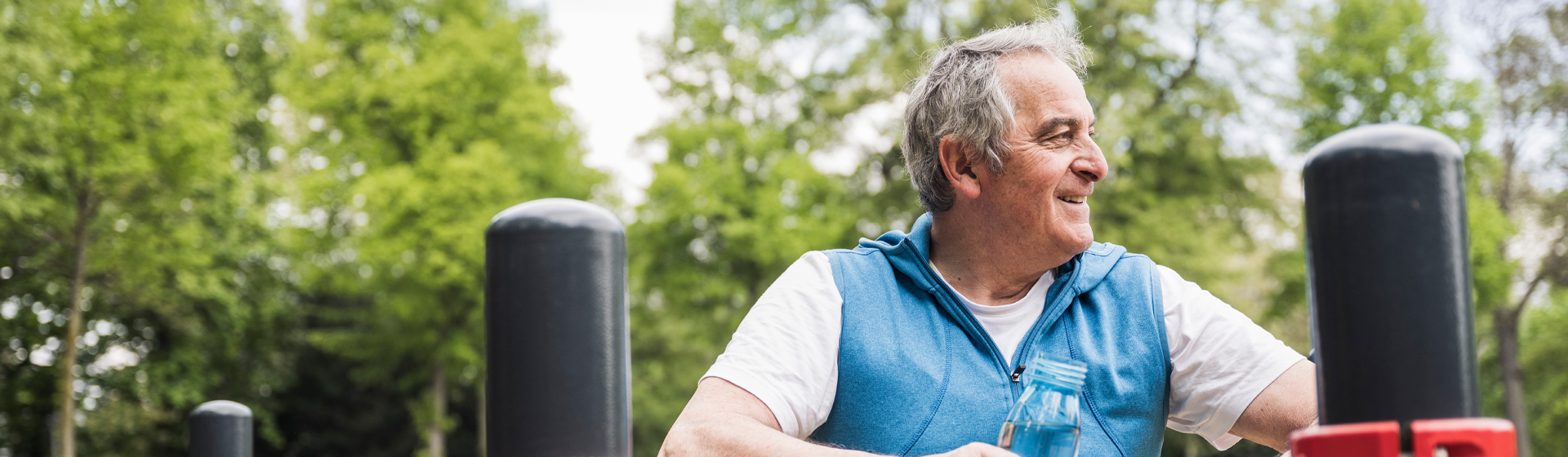 Man with water bottle looks off into distance
