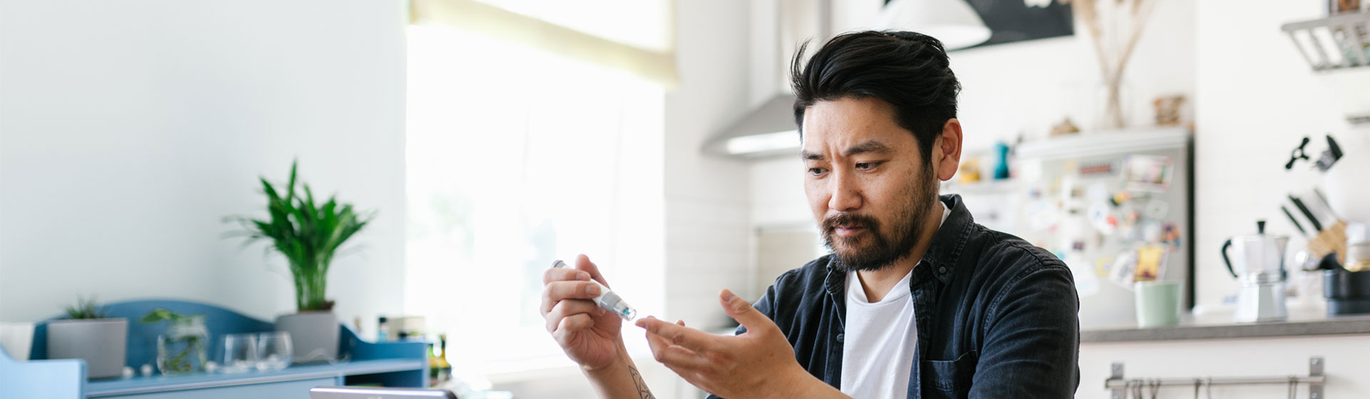 Asian Man Taking Insulin Shot for Diabetes Management